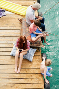Family fishing off of a dock